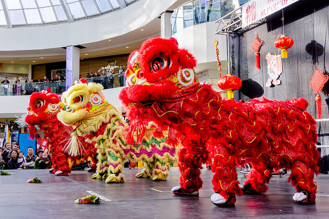 A trio of Lion dancers preparing to dance at the Chinese new year